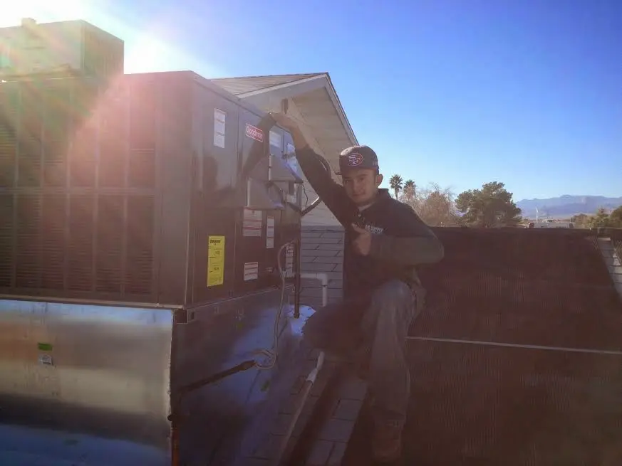 HVAC technician performing HVAC Inspection on a rooftop unit in Crestwood